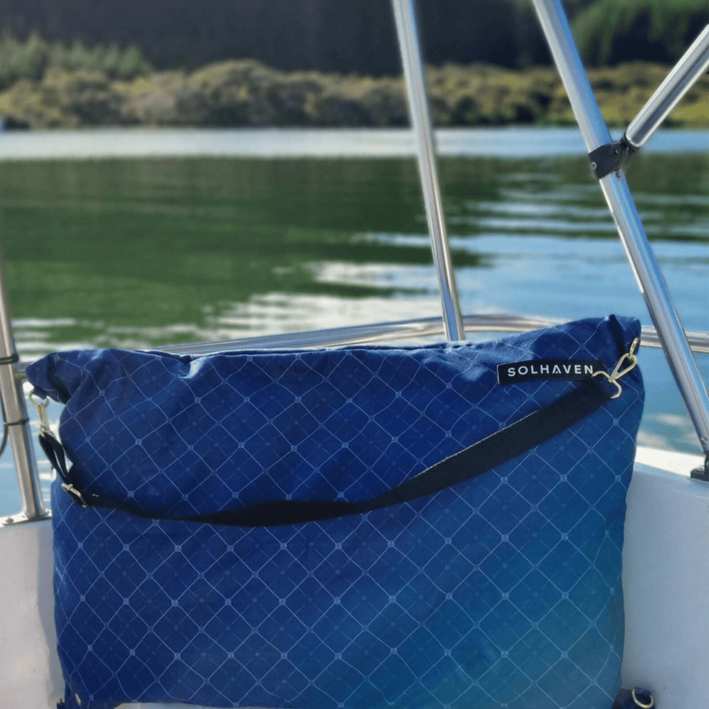 Dream First™ Pillow Bag - Haven - Solhaven sitting on the back of a boat with water of a lake in the background