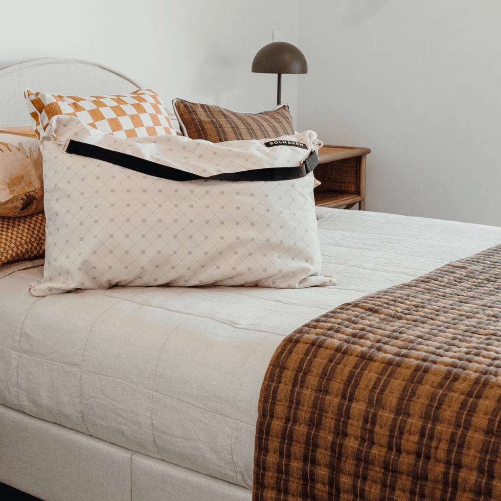 Solhaven Dream First™ Pillow Bag - Sole - a bag and pillow sitting on a bed