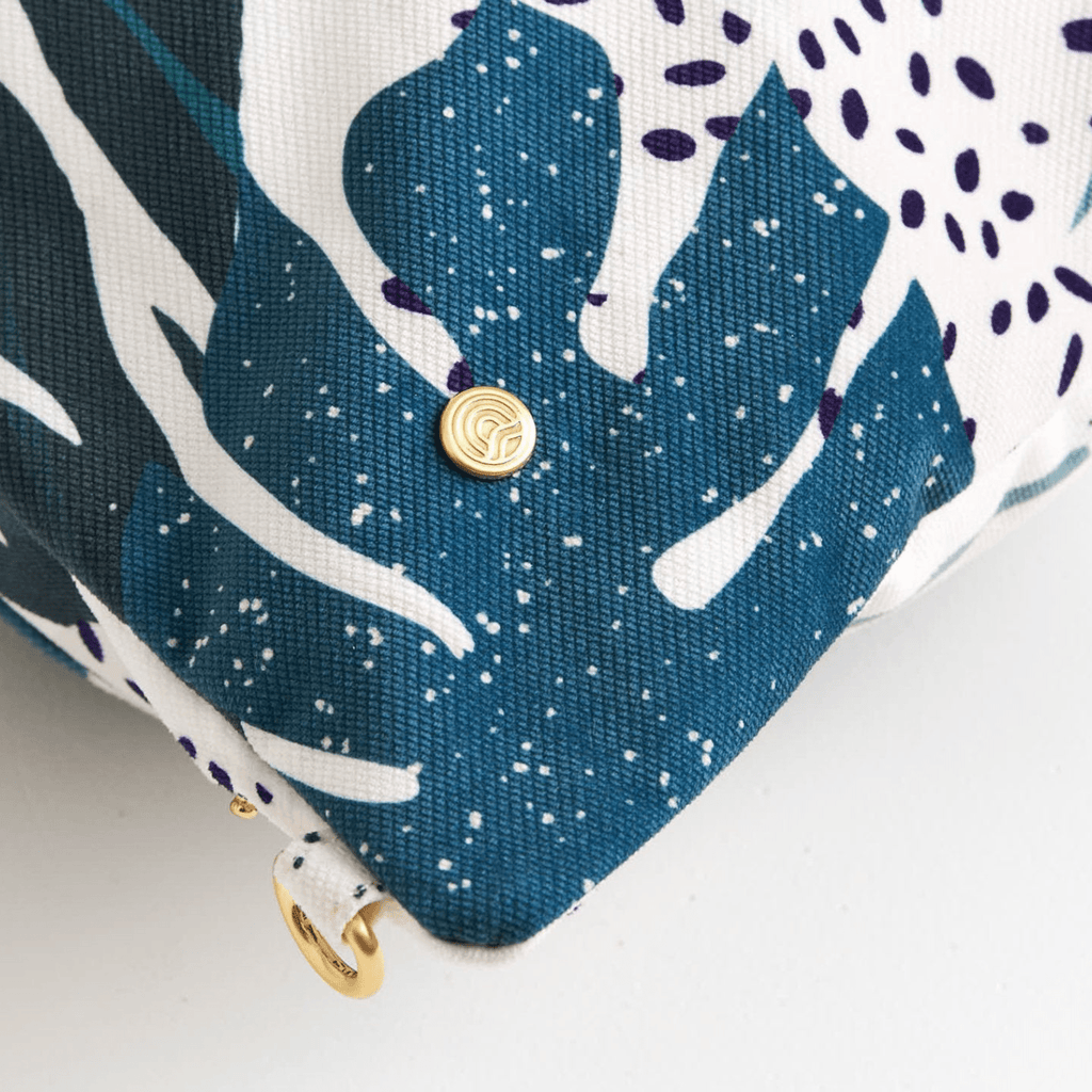 Dream First™ Pillow Bag - Tropic - Solhaven showing brushed gold icon dome on the corner of the bag