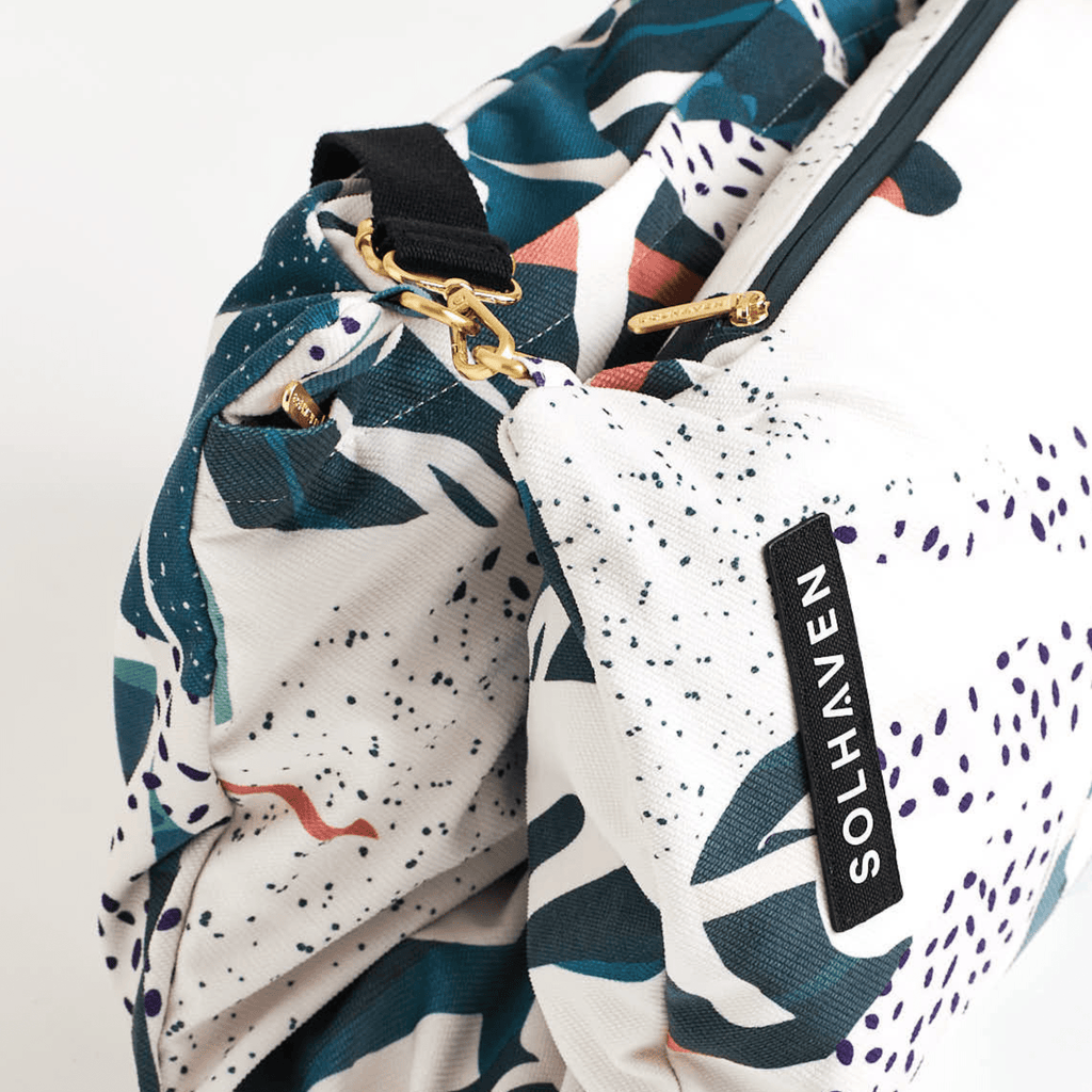 Dream First™ Pillow Bag - Tropic - Solhaven, folded in half showing brushed gold zips and buckles